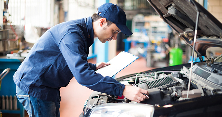A mechanic working in a vehicle.