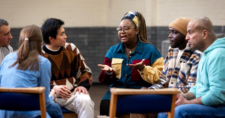 Image of a diverse group of people sitting in a circle having a discussion
