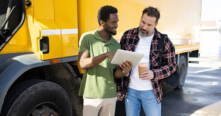 An image of a telematics service provider (TSP) representative talking to a fleet leader about implementing a telematics solution for their fleet business