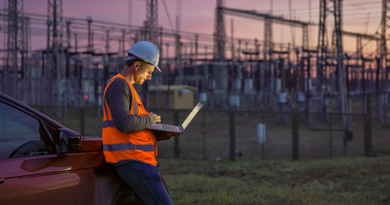 An image of a utility worker inspecting utility lines to ensure reliability.